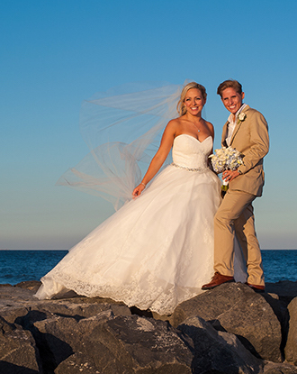 Bride and Groom on Rocks at the beach